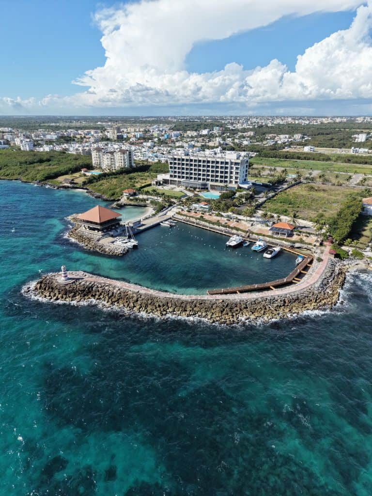 A stunning aerial view of a coastal resort with marina and lush surroundings in Punta Cana.