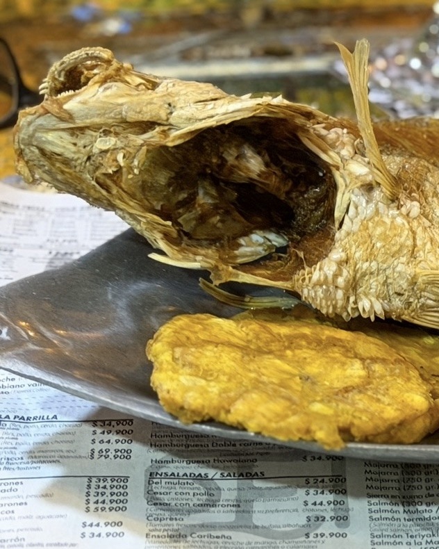 Whole fried fish with tostones and coconut rice, a Caribbean coastal dish