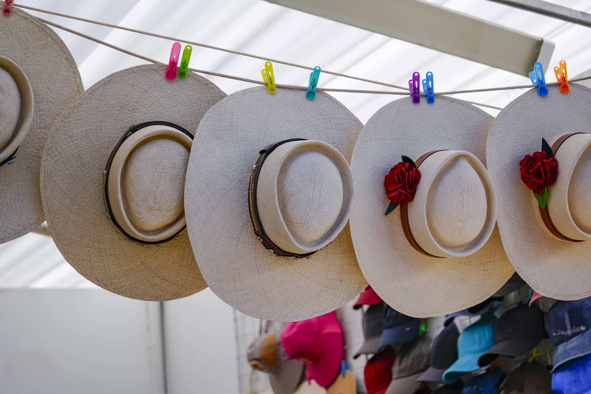 Colorful straw hats and souvenirs on display at a market stall in Santo Domingo