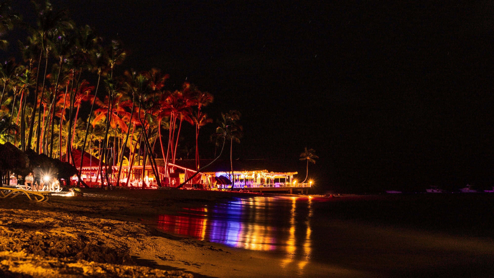 Beachside bar and restaurant lit up at night in Puerto Plata